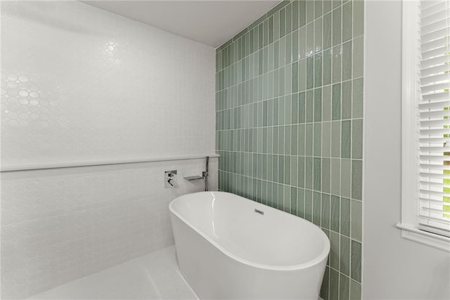 full bath featuring tile walls and a soaking tub