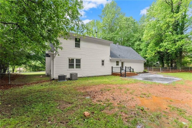 rear view of house featuring central air condition unit, a patio area, and a wooden deck