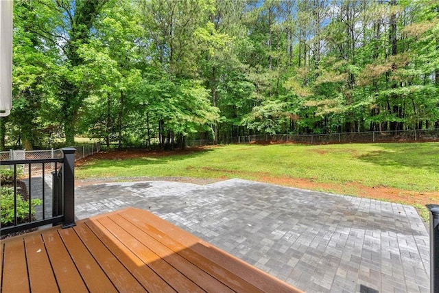 deck with a patio and view of wooded area