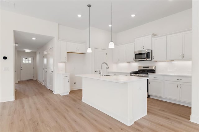 1216 Cedarcrest Blvd, Acworth, GA 30101 - kitchen featuring light wood finished floors, a sink, white cabinetry, and appliances with stainless steel finishes