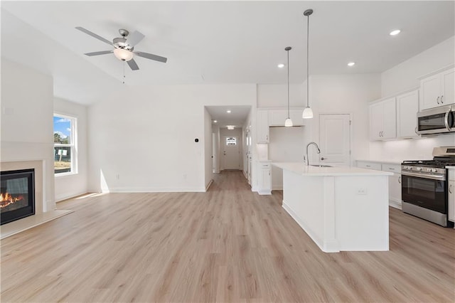 1216 Cedarcrest Blvd, Acworth, GA 30101 - kitchen featuring a sink, open floor plan, light wood-style floors, light countertops, and appliances with stainless steel finishes
