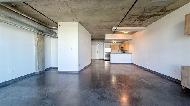 basement with stainless steel fridge