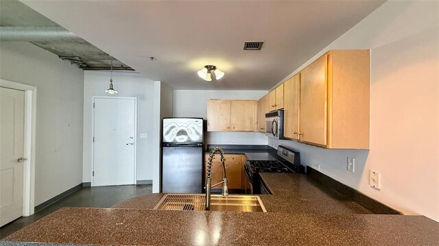 kitchen with sink, kitchen peninsula, hanging light fixtures, stainless steel appliances, and light brown cabinets