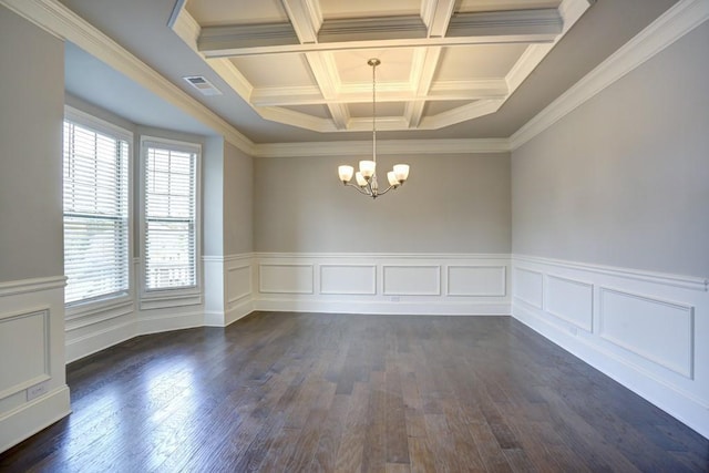 empty room featuring beam ceiling, coffered ceiling, dark hardwood / wood-style flooring, crown molding, and a chandelier