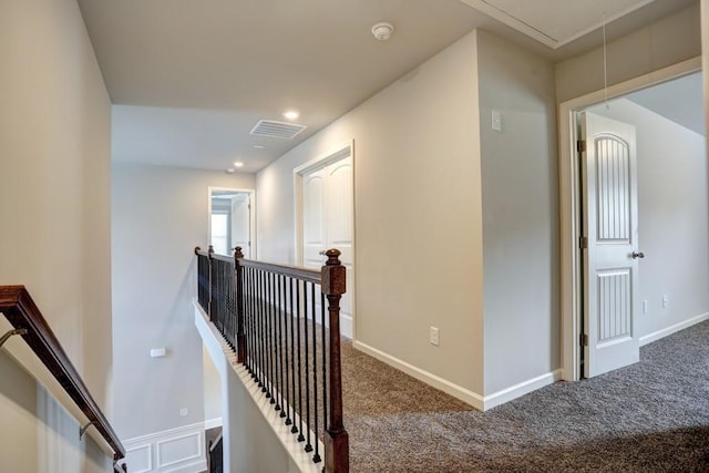 hallway with carpet floors