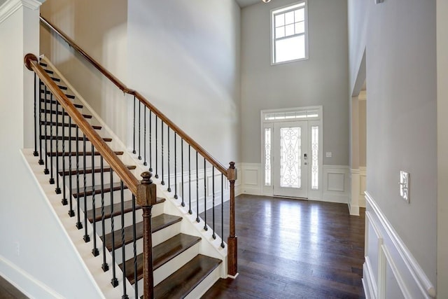 foyer featuring a high ceiling and dark wood-type flooring