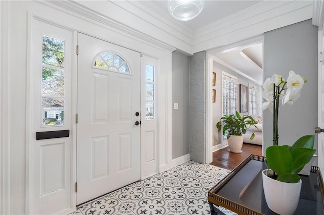 foyer entrance with light wood-type flooring and crown molding