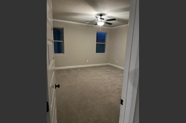 spare room featuring crown molding, carpet floors, and ceiling fan