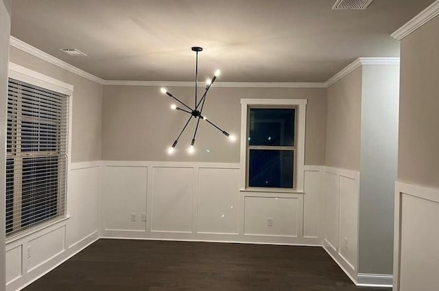 unfurnished dining area featuring crown molding, a chandelier, and dark hardwood / wood-style floors