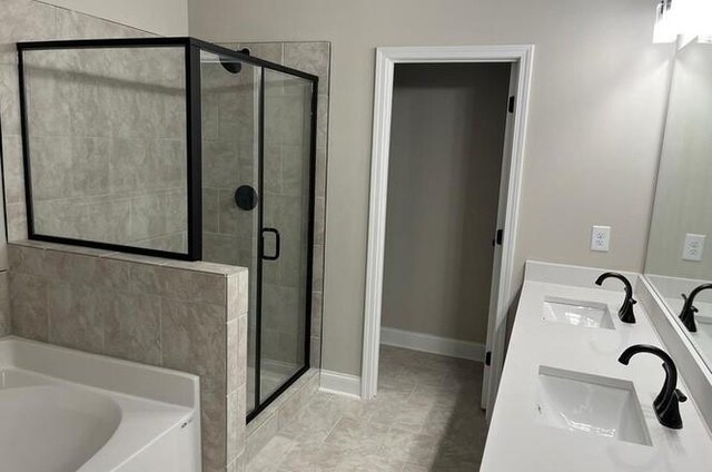 bathroom featuring vanity, plus walk in shower, and tile patterned flooring