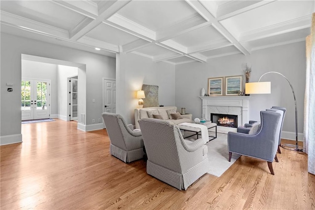 living room with a fireplace, baseboards, light wood-type flooring, french doors, and coffered ceiling