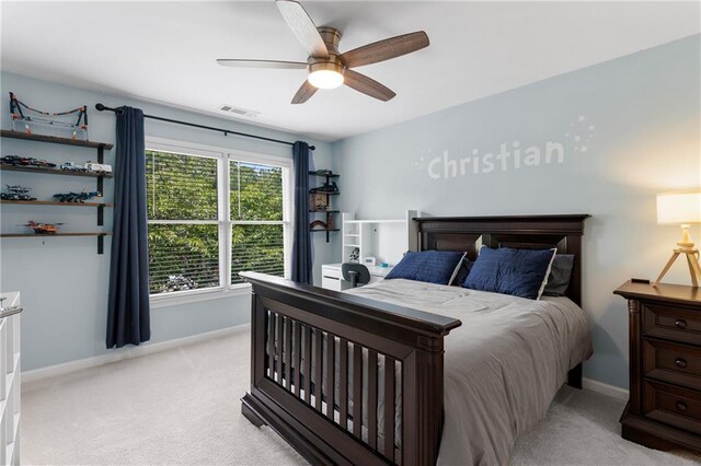 bedroom with light colored carpet, a ceiling fan, and baseboards