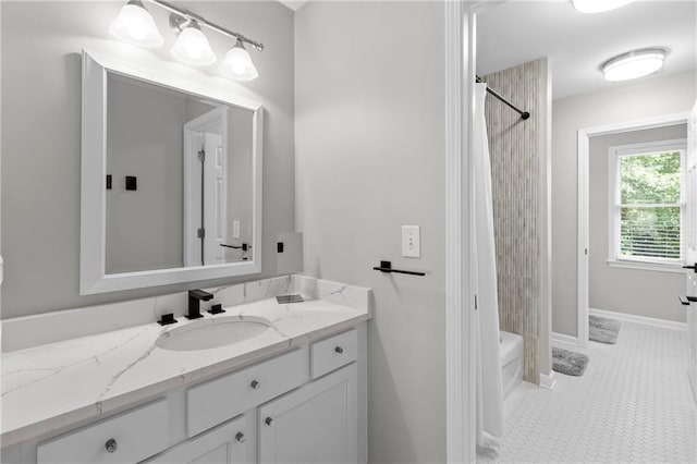 bathroom featuring baseboards, shower / tub combo with curtain, and vanity