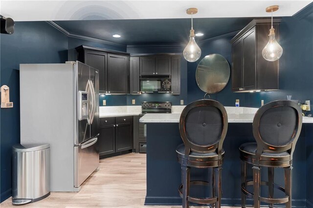 kitchen with black microwave, stainless steel fridge with ice dispenser, light countertops, a peninsula, and range with electric stovetop