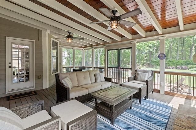 sunroom featuring ceiling fan and beam ceiling