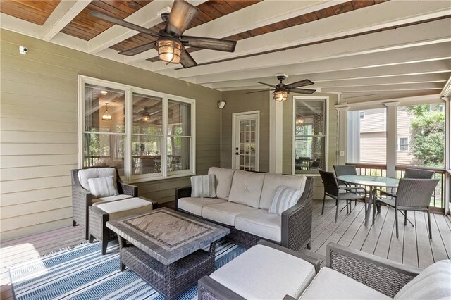 sunroom with outdoor dining space, ceiling fan, beam ceiling, and outdoor lounge area