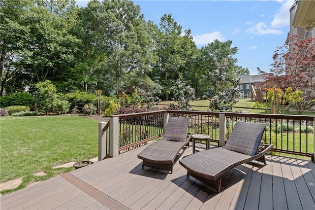 wooden terrace featuring a yard