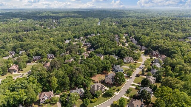 birds eye view of property with a residential view and a wooded view