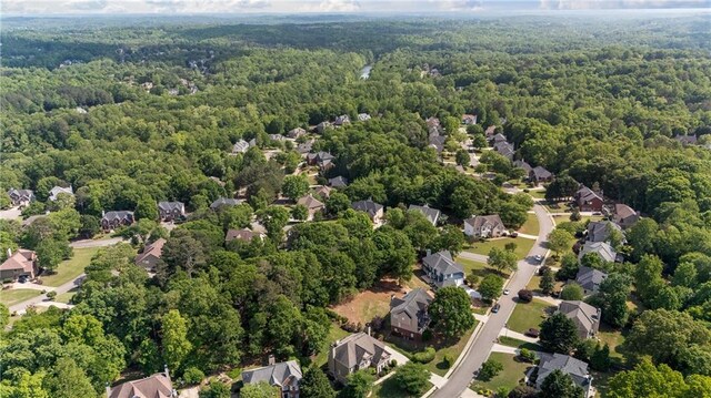 drone / aerial view with a forest view and a residential view