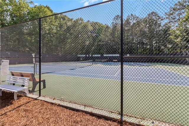 view of tennis court featuring fence