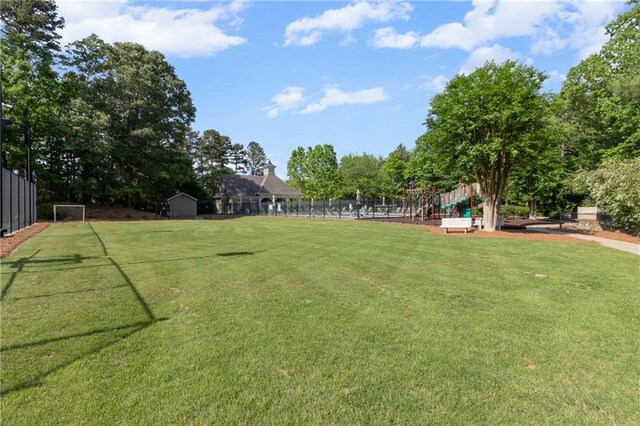 view of tennis court featuring fence