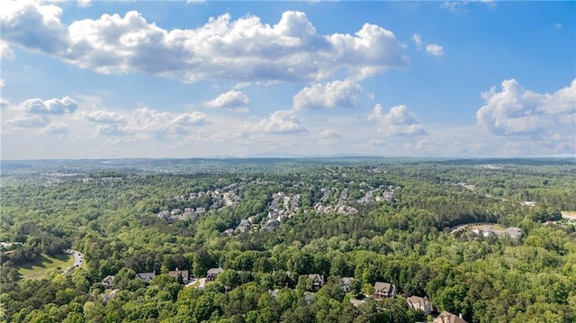 birds eye view of property featuring a view of trees