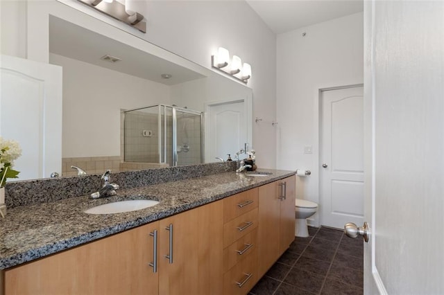 390 17th St NW Unit 6036, Atlanta, GA 30363 - bathroom featuring double vanity, a shower stall, tile patterned flooring, and toilet