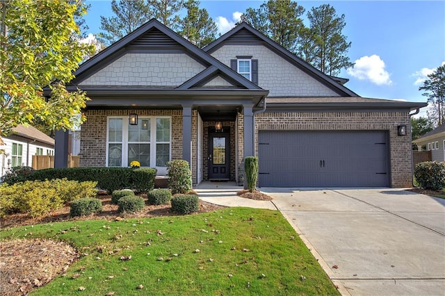 craftsman house featuring a garage and a front lawn