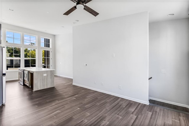 unfurnished room featuring ceiling fan and dark hardwood / wood-style flooring