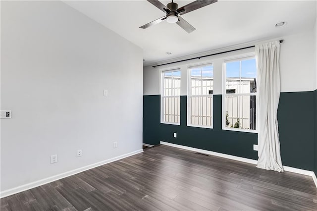 unfurnished room with ceiling fan and dark hardwood / wood-style floors