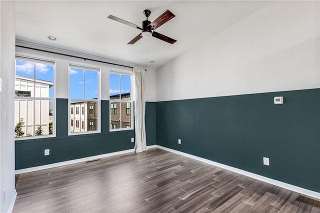 unfurnished room featuring ceiling fan and dark hardwood / wood-style flooring