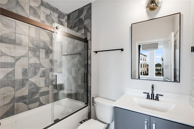 full bathroom featuring bath / shower combo with glass door, vanity, and toilet