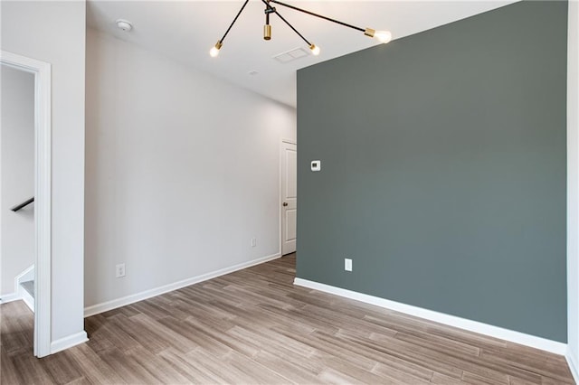 empty room with light hardwood / wood-style flooring