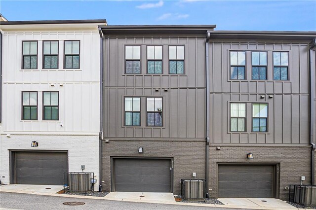 exterior space with cooling unit and a garage