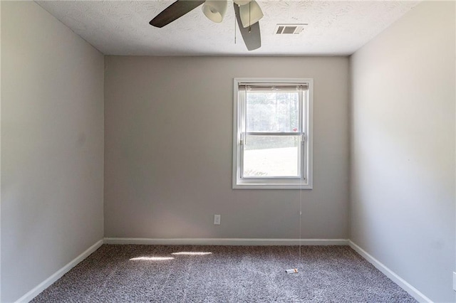 empty room with baseboards, ceiling fan, visible vents, and carpet floors