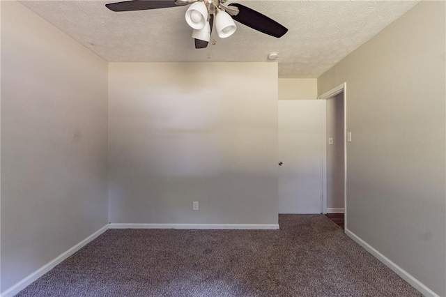 carpeted spare room featuring a ceiling fan, baseboards, and a textured ceiling