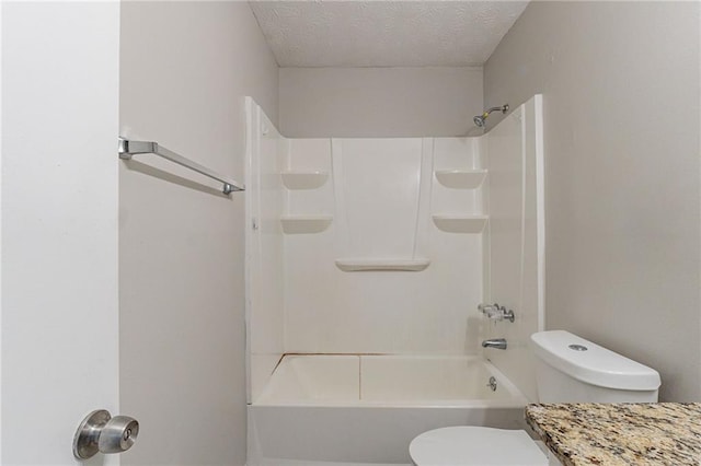full bath with toilet and a textured ceiling