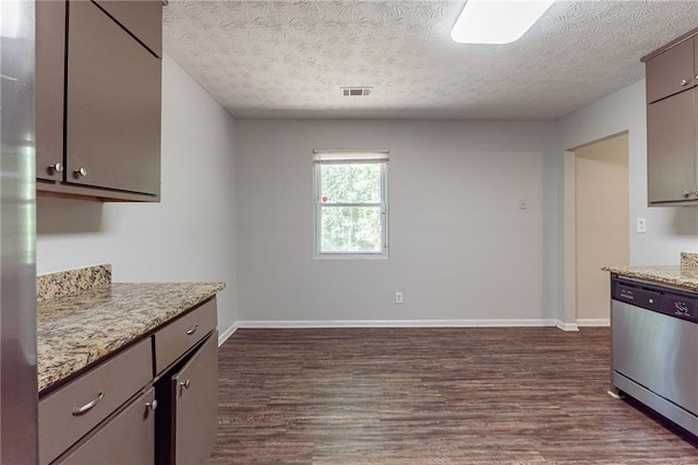 kitchen with a textured ceiling, dark wood-style floors, visible vents, and stainless steel dishwasher