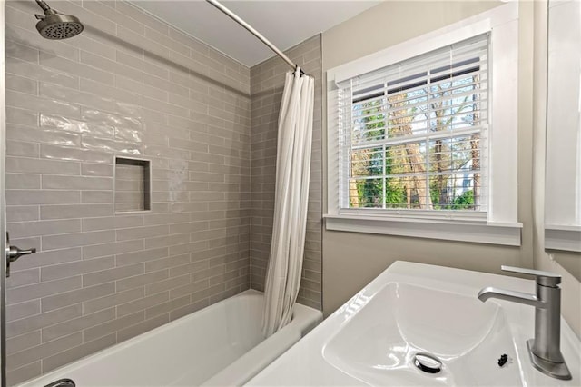 bathroom with shower / tub combo and sink