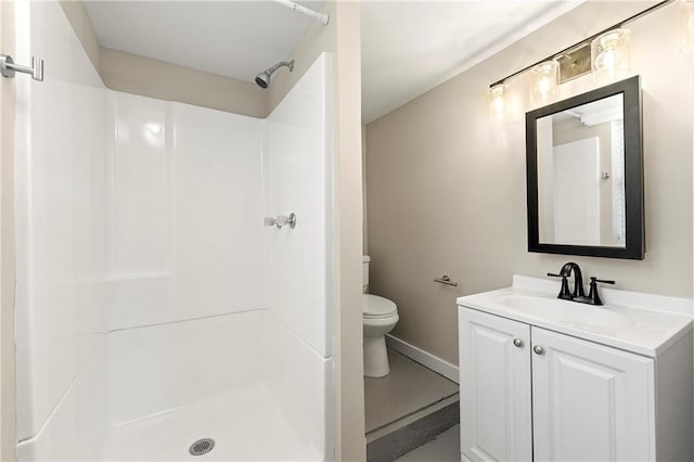 bathroom featuring vanity, a shower, and toilet