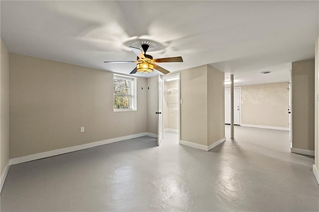 spare room featuring concrete floors and ceiling fan