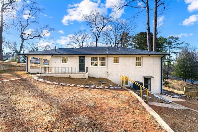 rear view of property featuring a porch