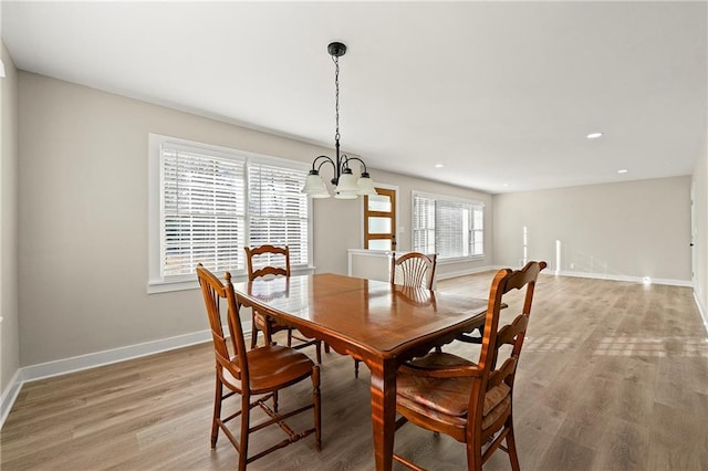 dining room featuring an inviting chandelier and light wood-type flooring