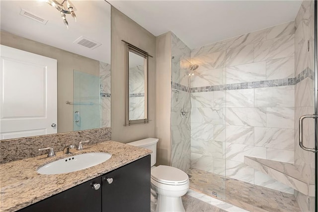 bathroom featuring vanity, toilet, and an enclosed shower