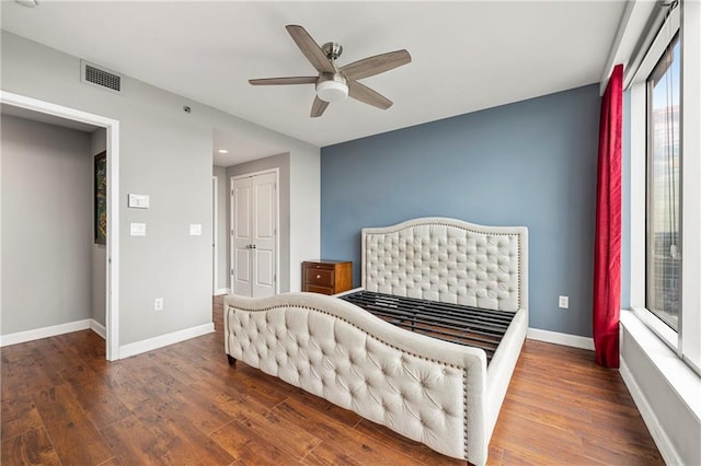 bedroom featuring ceiling fan, a closet, and dark hardwood / wood-style flooring