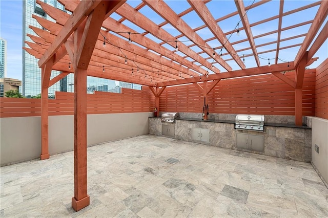 view of patio / terrace with grilling area, a pergola, and exterior kitchen