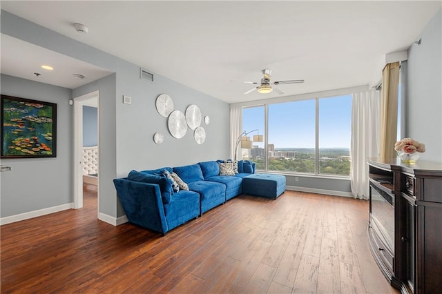 living room featuring hardwood / wood-style flooring and ceiling fan