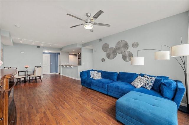 living room featuring ceiling fan and dark hardwood / wood-style flooring