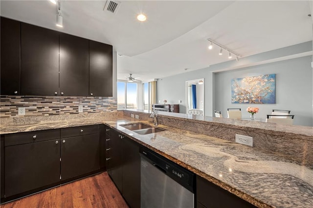 kitchen featuring light stone counters, decorative backsplash, dark hardwood / wood-style floors, sink, and dishwasher