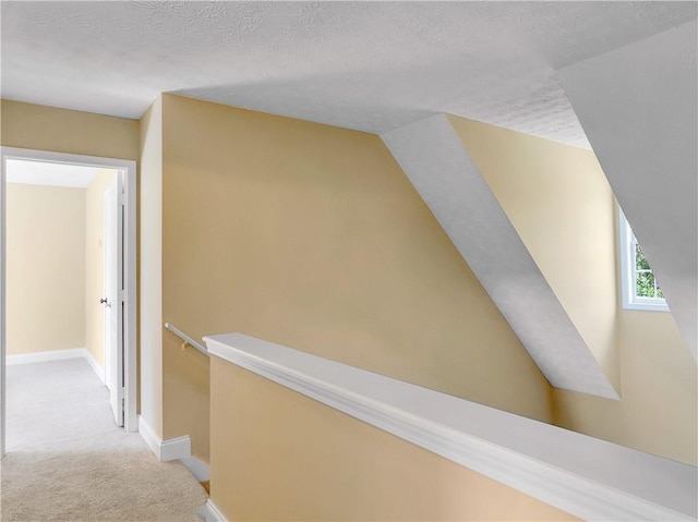 1012 Gloria Grand Blvd, Mcdonough, GA 30252 - hallway with an upstairs landing, light carpet, baseboards, and a textured ceiling